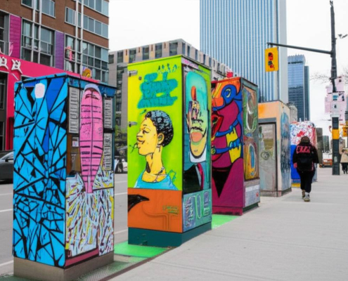 Decorated electrical boxes in Toronto showcasing vibrant public art.