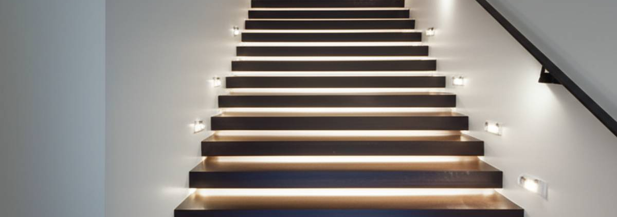 Motion sensor stair lights Toronto: Modern dark wood staircase with soft, diffused lighting.