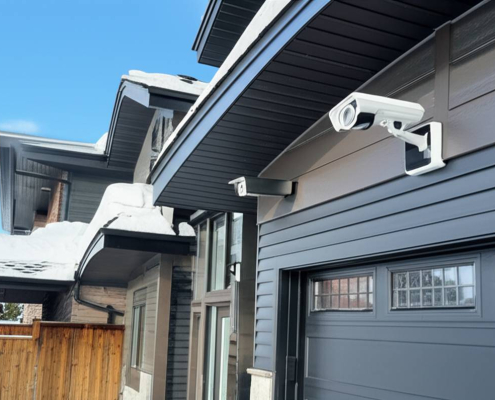 Modern Canadian home with discreet security cameras in winter.
