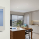 Smart Home Technology Keswick: Modern interior with smart thermostat, voice assistant, & automated blinds.