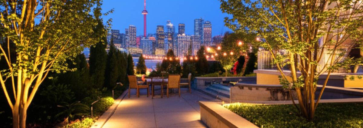 Low Voltage Lighting Toronto: Modern backyard patio illuminated at dusk.