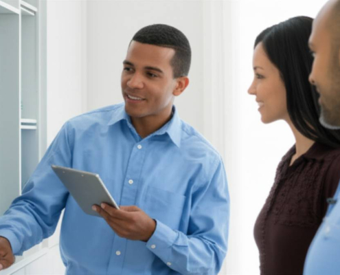 Low voltage wiring Toronto: Electrician explaining energy savings to homeowner.