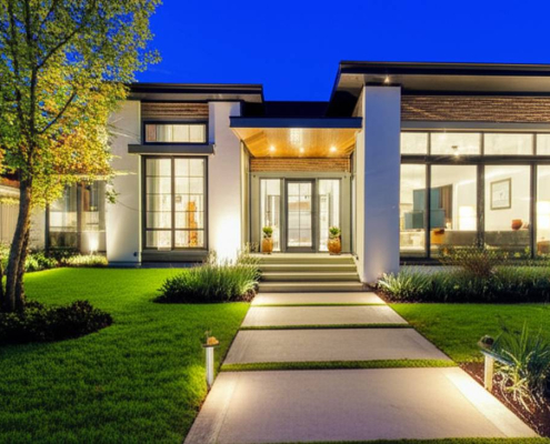 GTA home exterior with low voltage landscape lighting at twilight.