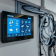 Modern smart home panel displaying integrated lighting, climate, and security systems, highlighting the Home Automation Benefits provided by PowerSol.